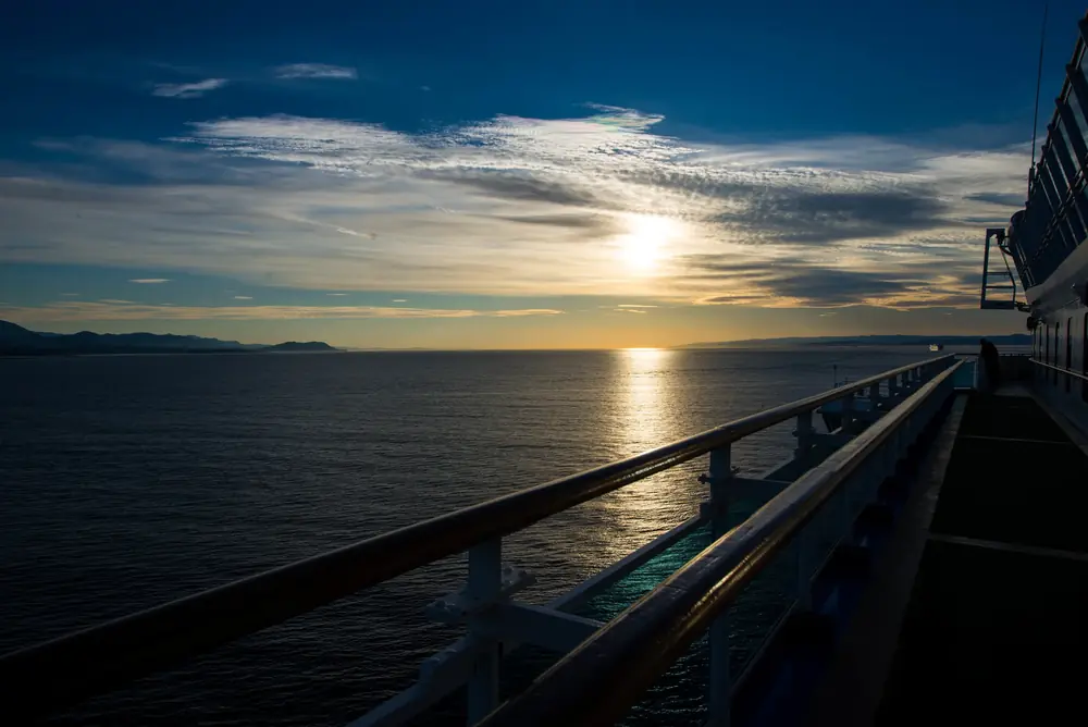 Sun low over the water, seen from a ship's rail