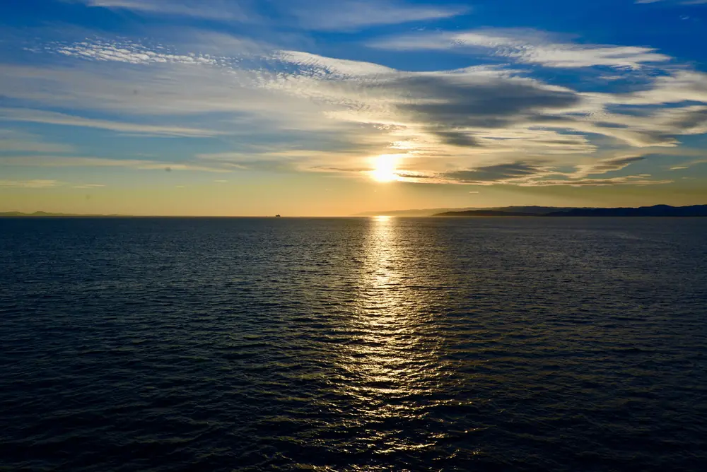 Streaked clouds over the sea at sunset