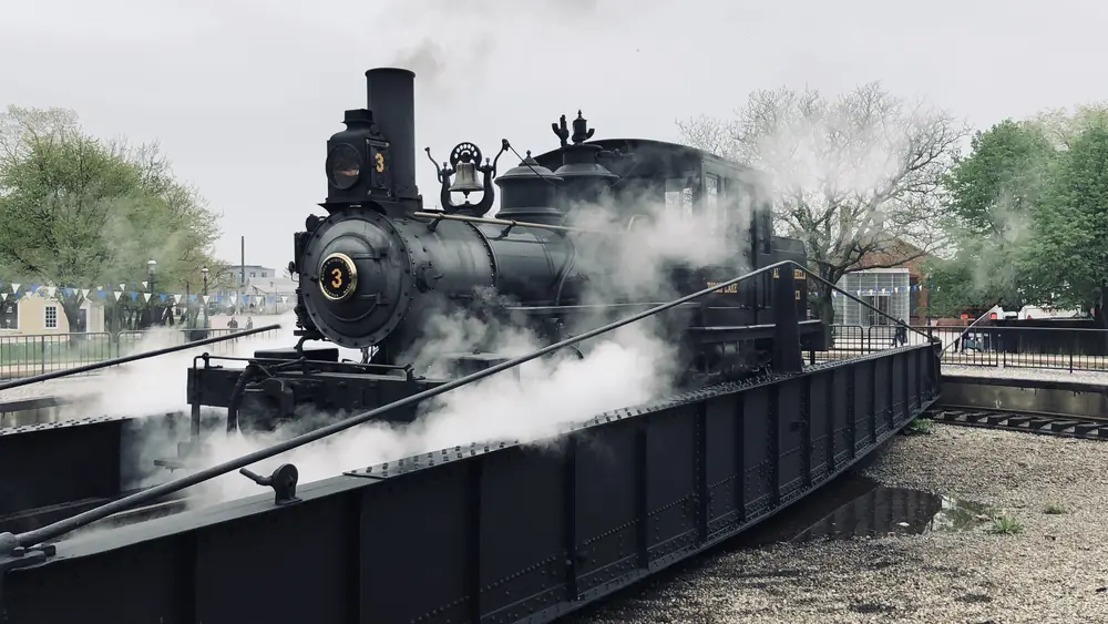Steam locomotive venting steam, in black and white