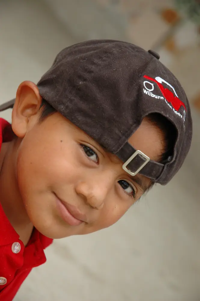 Boy in a backwards cap looking into the lens