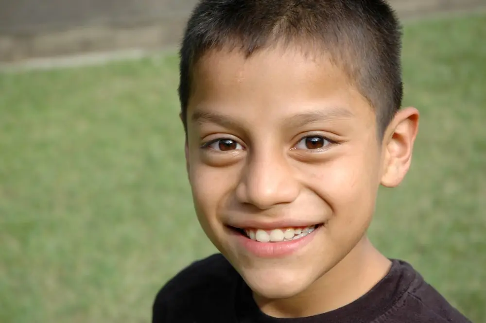Boy smiling on a green field