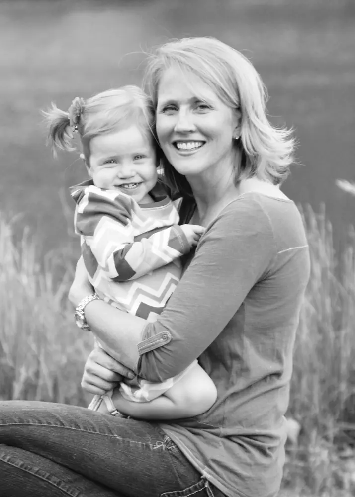 Mother and toddler in tall grass, in black and white