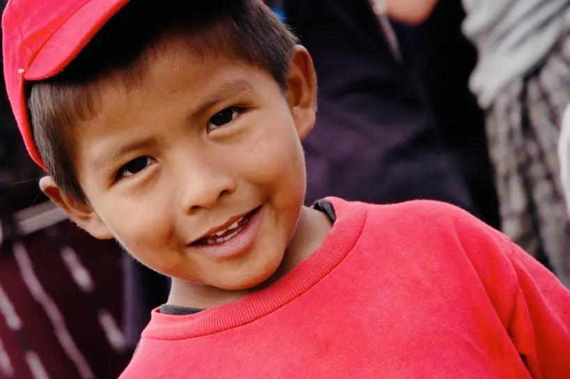 Small boy in a red cap and sweater, close up