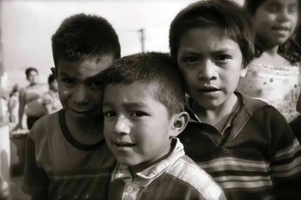 A group of boys crowded together, in sepia tones
