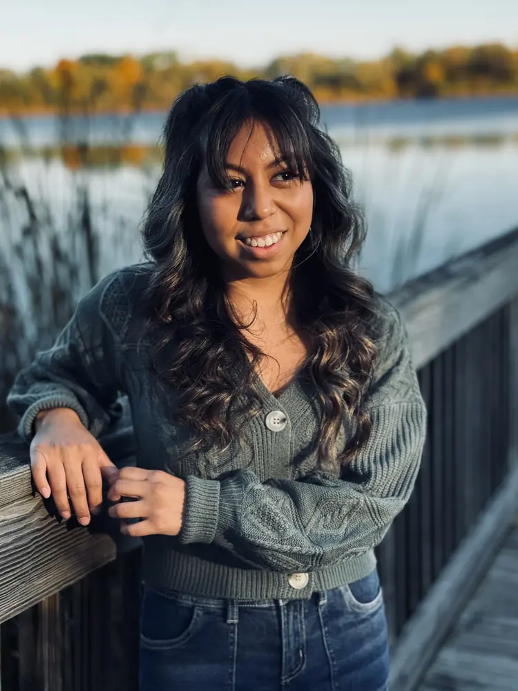 Woman leaning on a boardwalk rail in autumn